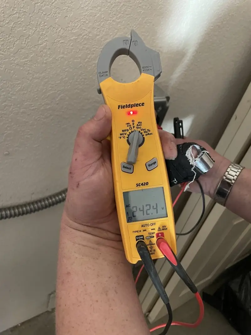 Voltage testing with clamp meter during Recessed Lighting Installation in North Branford